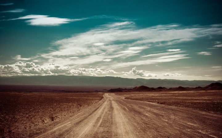 Empty Rural Road Going Through Prairie Under Cloudy Sky In Charyn Canyon